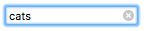Fokussiertes Suchfeld, mit Fokus-Ring, mit dem Text 'cats'. Es gibt ein x-Symbol im Eingabefeld an der rechten Seite.